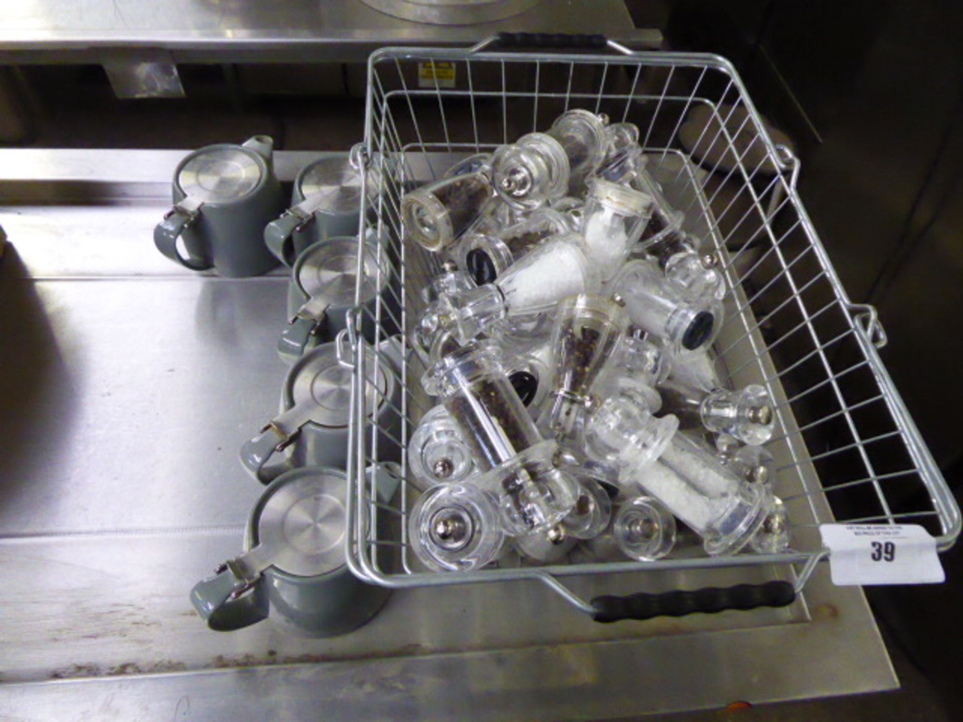 Basket containing salt and pepper mills with 5 teapots