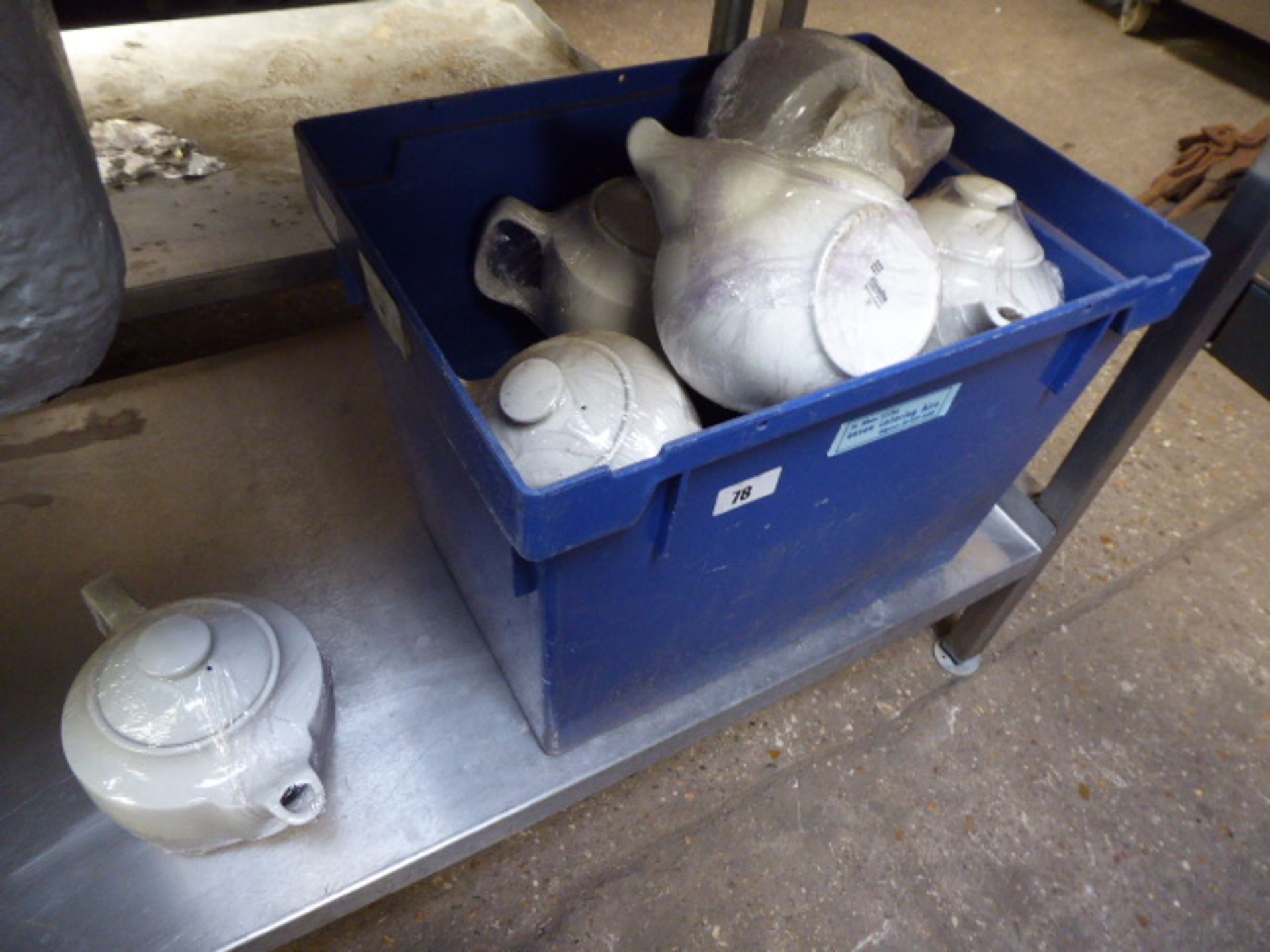 Blue plastic box containing Steelite white teapots