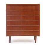 A 1970's Danish teak chest of six drawers on turned legs, w.