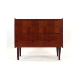 A 1970's Danish teak chest of four long drawers on turned legs, l.