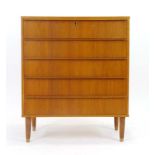 A 1970's oak and crossbanded chest of five drawers on later turned legs, w.