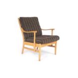 A 1960's Danish designed beech framed open armchair with loose striped cushions CONDITION