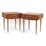 A pair of 1970's G-Plan teak single drawer bedside cabinets on later turned beech legs, w.