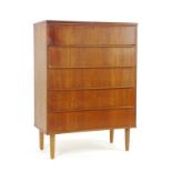 A 1970's teak chest of five drawers on later turned legs, w.