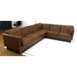 Georg Thams for Thams, a 1970's Danish brown leather corner sofa on an ebonised plinth, approx..