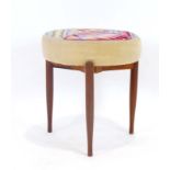 A 1960's upholstered dressing table stool on three teak tapering legs CONDITION REPORT: