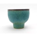 Abdo Nagi (1941-2001): a pedestal bowl, the mottled turquoise glaze with a bronzed rim,