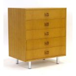 A 1970's Swedish oak chest of five drawers with carved handles, on spun aluminium tapering legs, w.