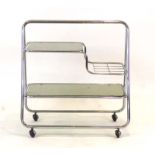 A 1970's chrome and smoked glass drinks trolley, the supports of triangular form, l.