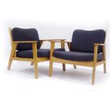 A pair of contemporary oak armchairs with loose charcoal upholstery