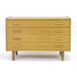 A Danish oak chest of four drawers on later turned legs, w.