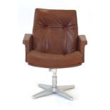 A 1970's brown button upholstered office chair on an aluminium four-star swivel base by Norma