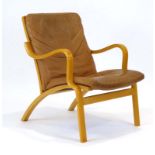 A Stouby beech framed lounge chair with loose tan upholstery