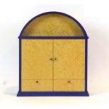 A dome-topped wall cabinet, the blue surround with burr maple doors and drawers, w.