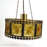 A 1970's brass coloured ceiling light with orange perspex panels and fleur de lis motifs