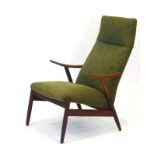 A 1960's teak and upholstered highback armchair with sweeping arms on tapering legs