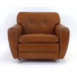 A 1970's tan leather and button upholstered lounge armchair on castors,