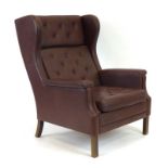 A 1970's Danish brown button upholstered wingback armchair in the Borge Mogensen manner