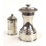 An early 20th century silver pepper grinder of waisted form with beaded border,