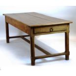 A Continental walnut refectory table, the surface overlapping the frieze with three drawers,