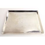 An early 20th century silver tray of rectangular form with honeycomb engine turned decoration,