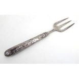A late Victorian silver bread fork, the handle repousse decorated in the Neo-Classical manner,