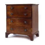 A Georgian mahogany commode with faux drawers on bracket feet, w.