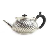 A Victorian silver teapot of squat melon shaped form with gadrooned decoration, maker JTH JHM,