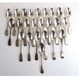 A mixed parcel of Georgian and later silver fiddle pattern dessert spoons, various dates and makers,