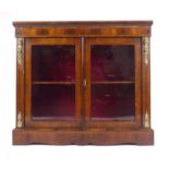 A 19th century walnut and strung pier cabinet, the pair of glazed doors enclosing a single shelf,