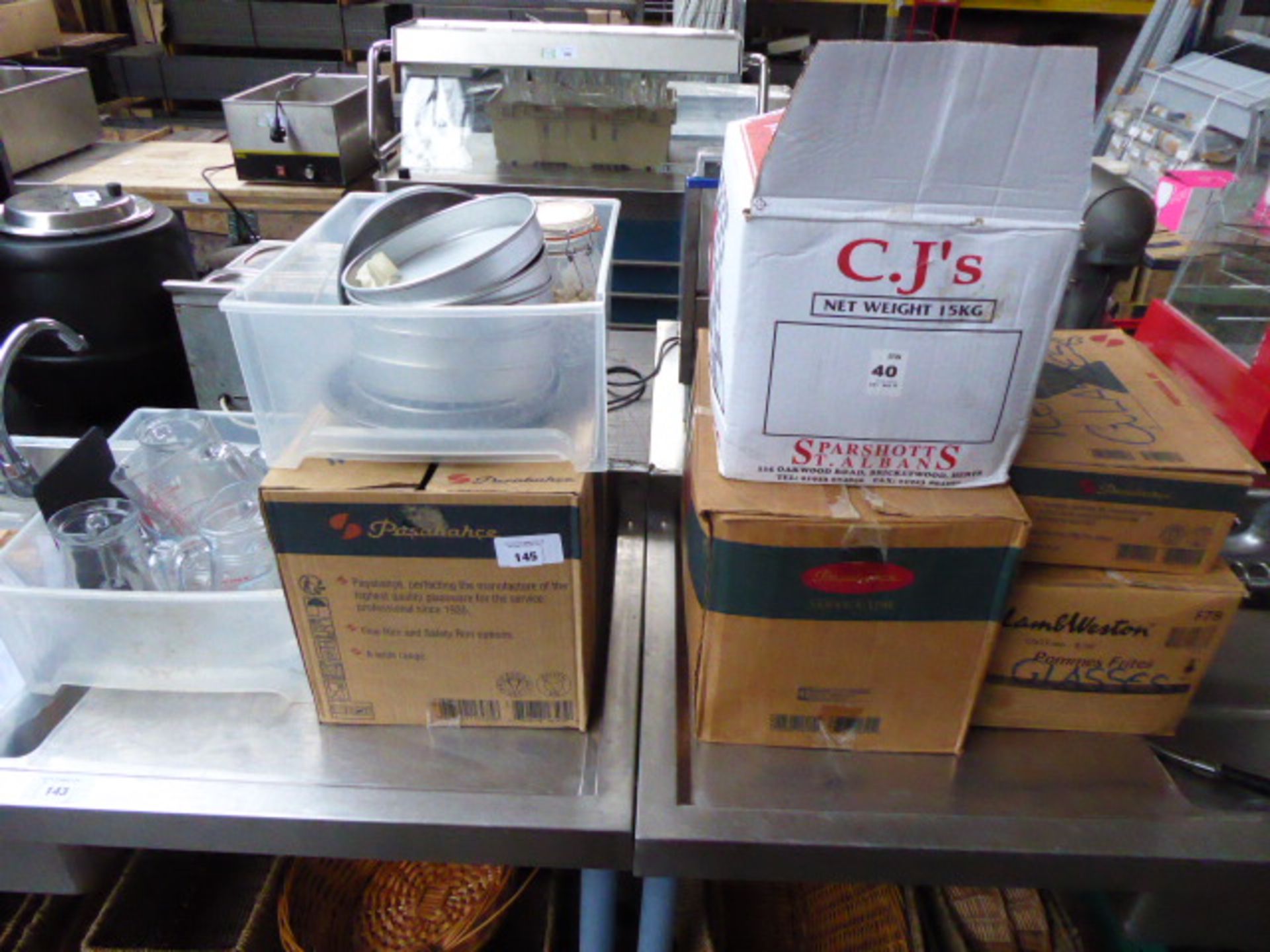 Four boxes of assorted glassware and two trays of water jugs, measuring jugs, cake tins etc