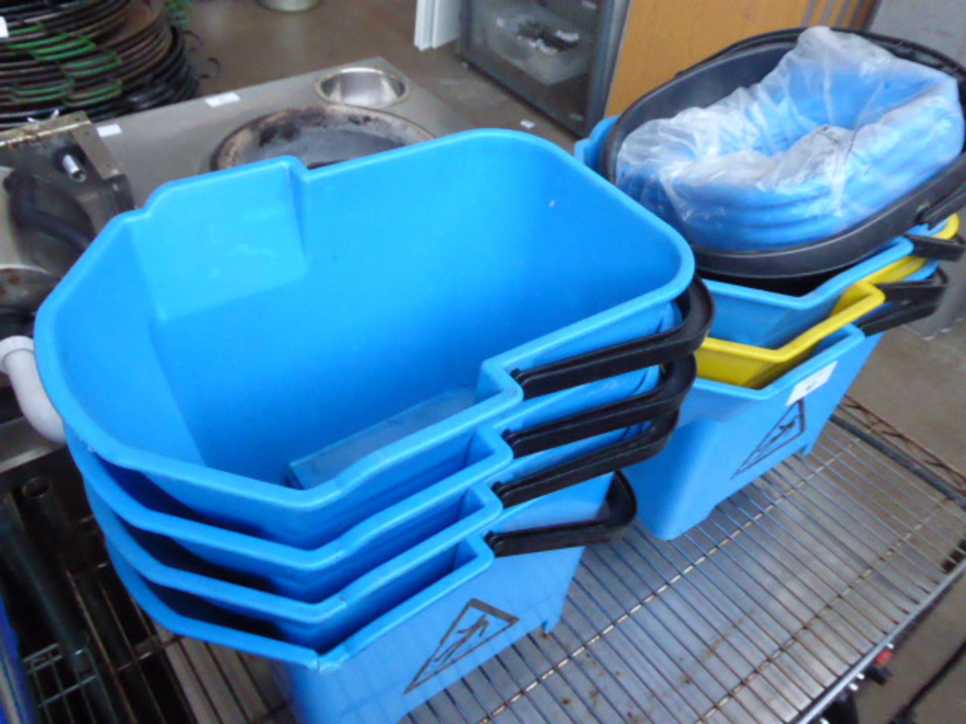 Shelf of mop buckets with wringers