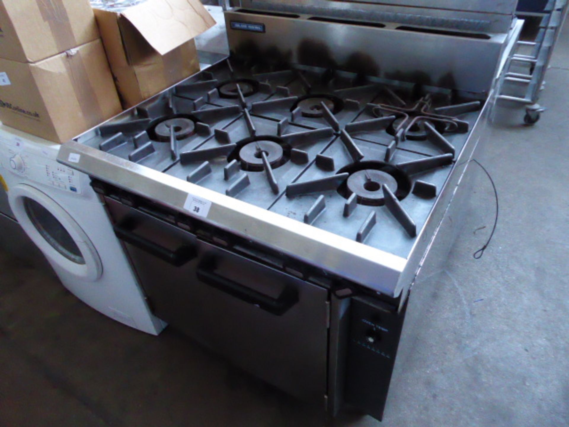 A 90cm gas six burner cooker with a double door oven under