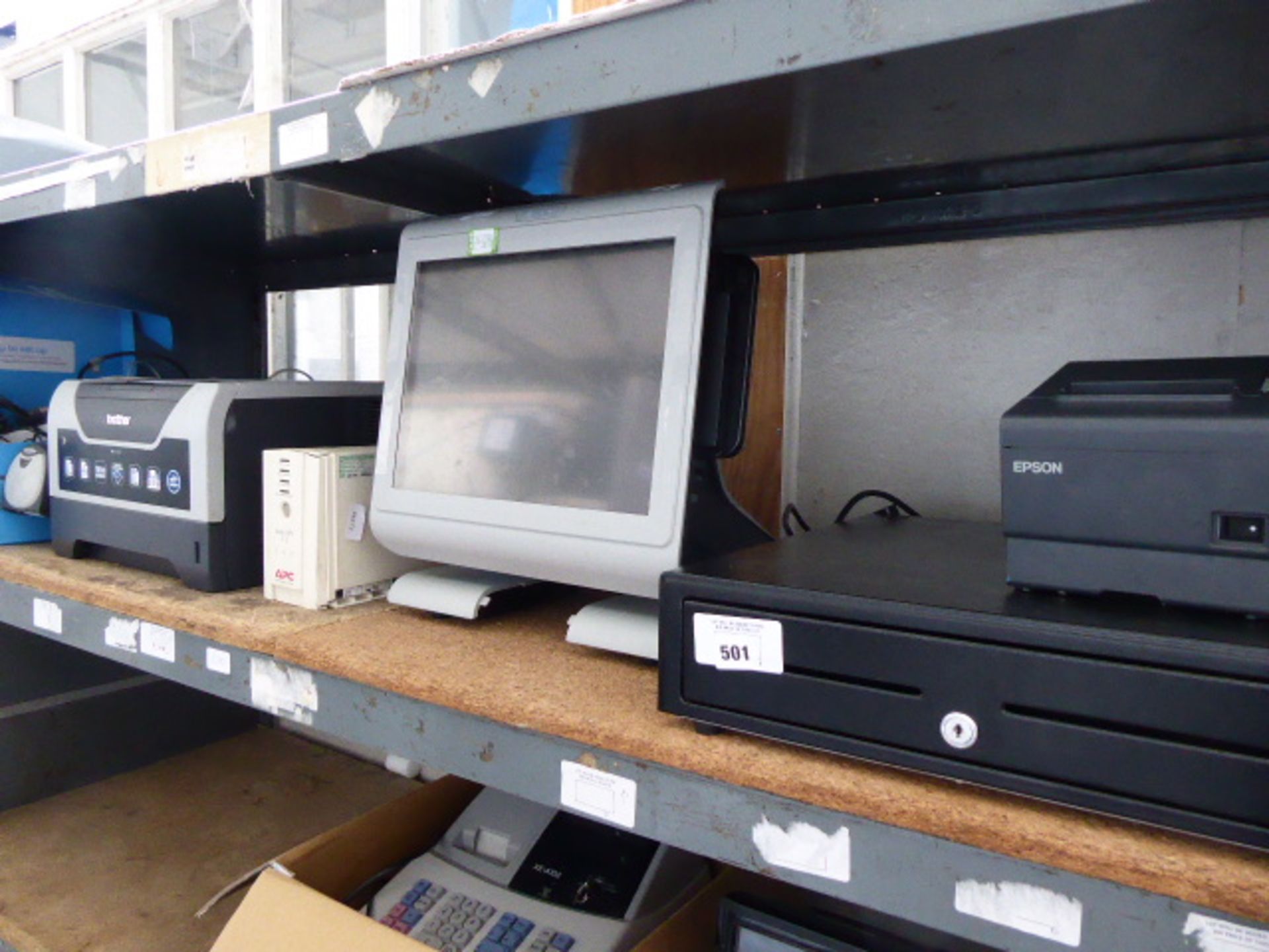 A shelf of EPOS systems, including touch screen terminal, cash drawer, printer, back up UPS unit and
