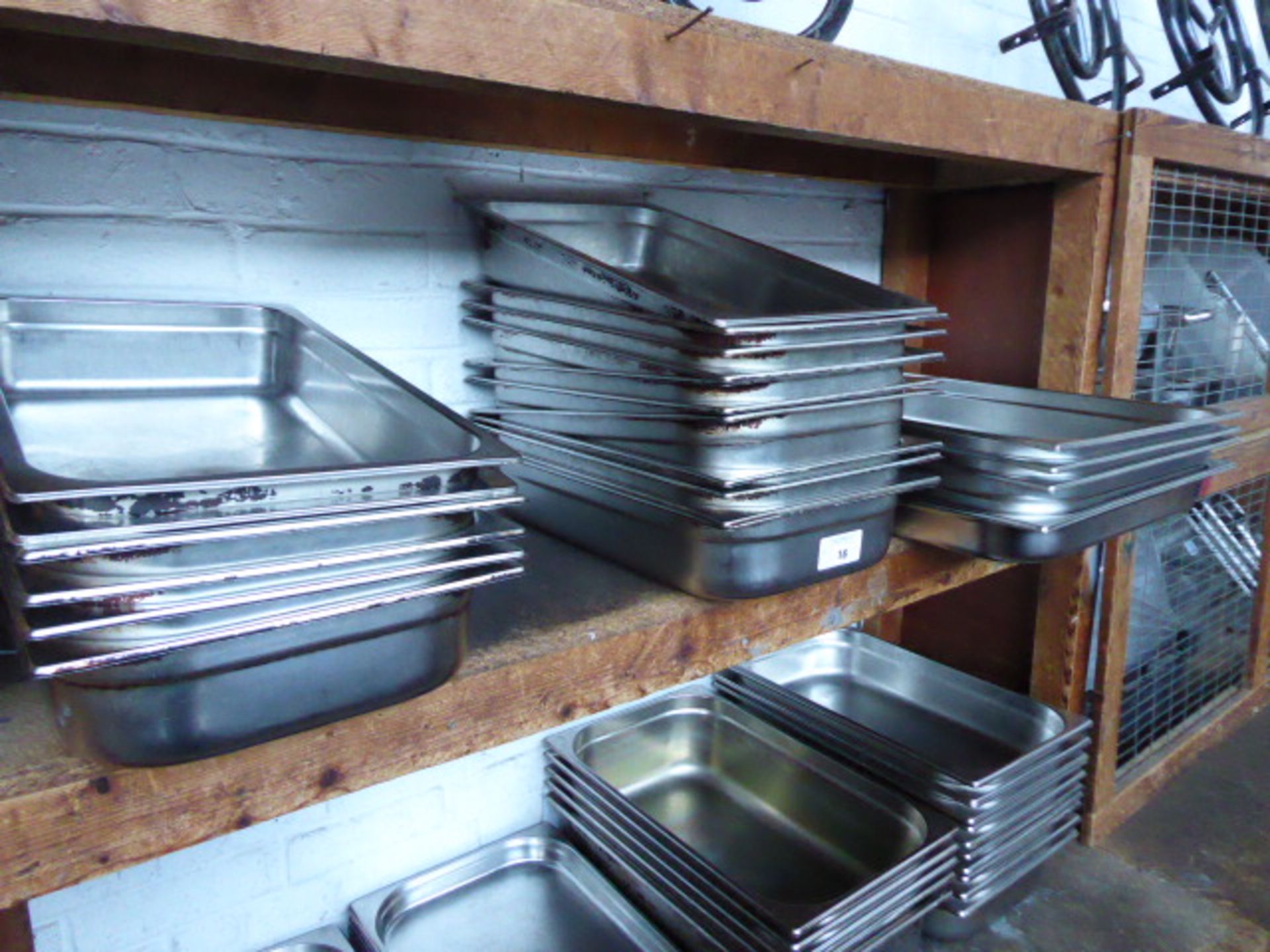 Four double size stainless steel Gastronorm pans trays and approximately fifteen stainless steel