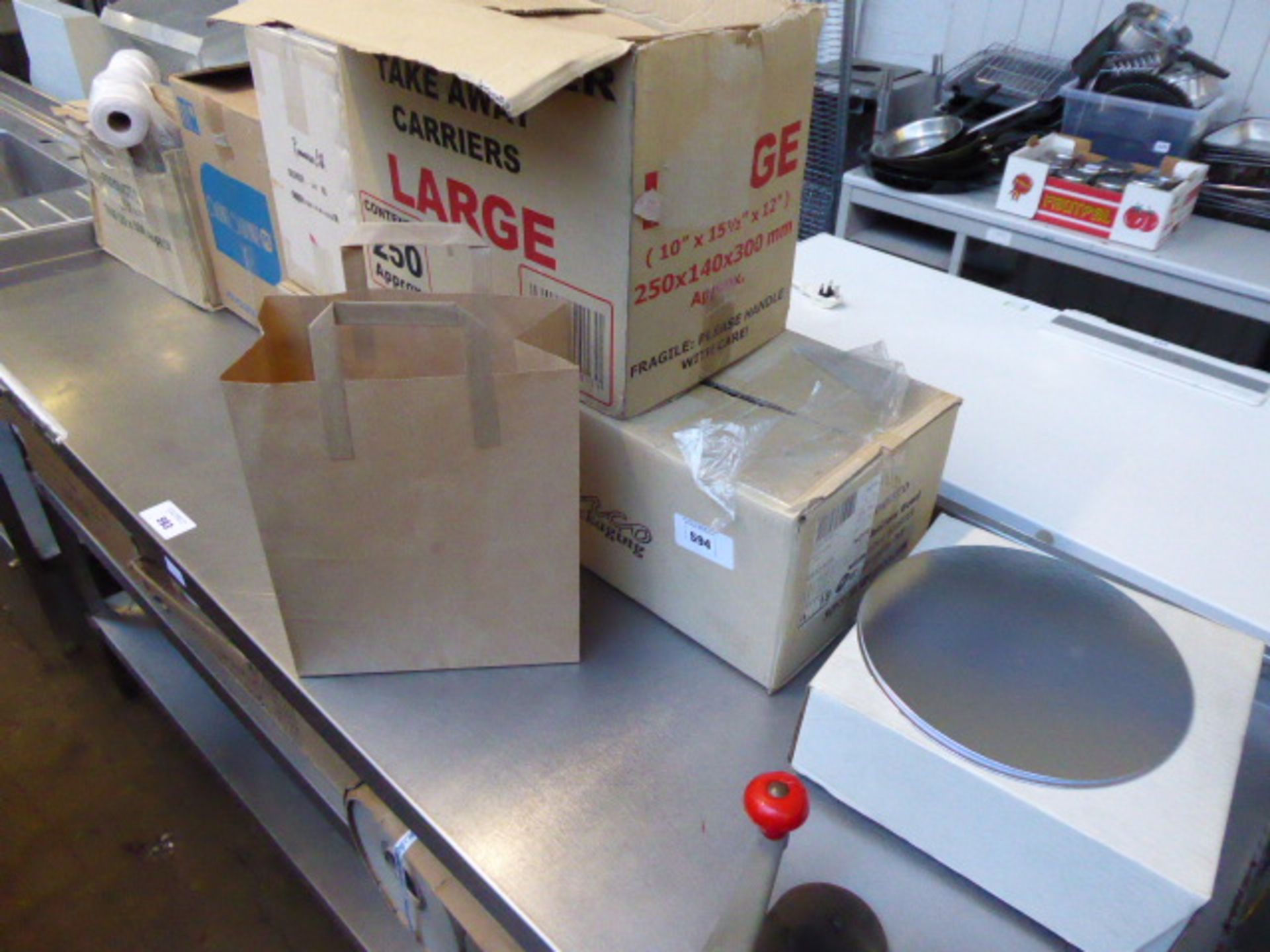 Two shelves of assorted take away containers and packaging