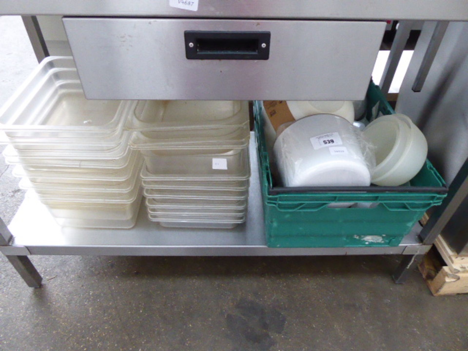 2 stacks of half size plastic gastronorm containers and a crate of assorted plastic wares