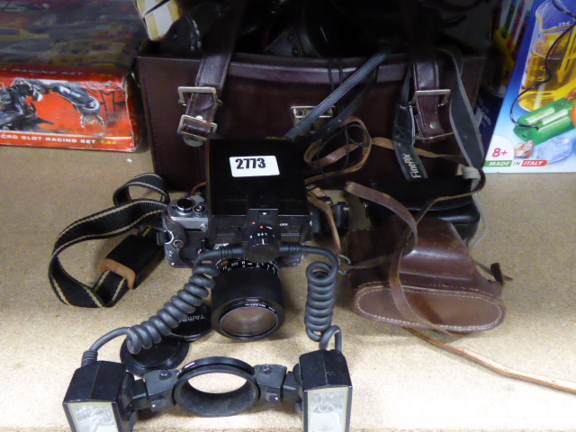 Large selection of vintage camera equipment in leather holdall inc. Olympus OM1 camera, specialist