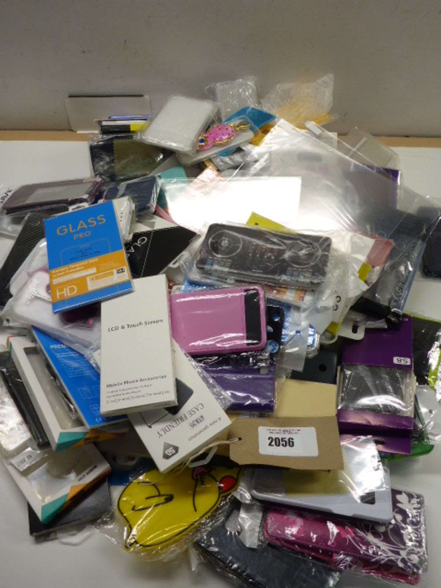 Bag of mobile phone screen protectors and cases.