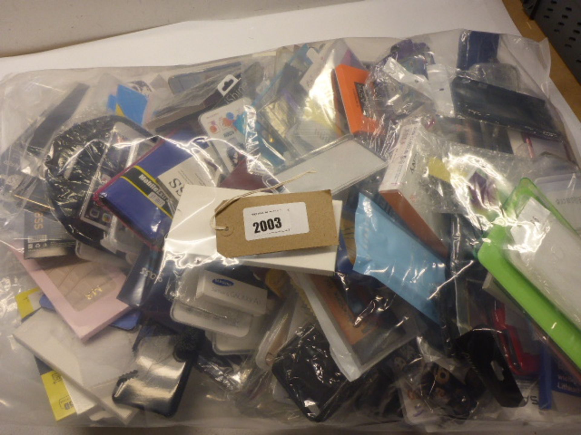 Bag containing large quantity of cases and screen protectors for mobile phones and tablets