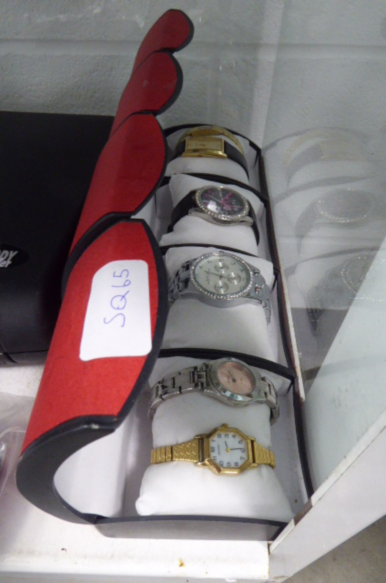 4 red cases of costume watches
