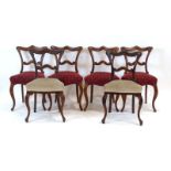 A set of four William IV rosewood and upholstered dining chairs with cabriole front legs,