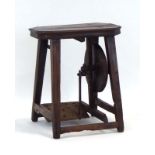 An oak treadle operated wheel, converted to a table, w.