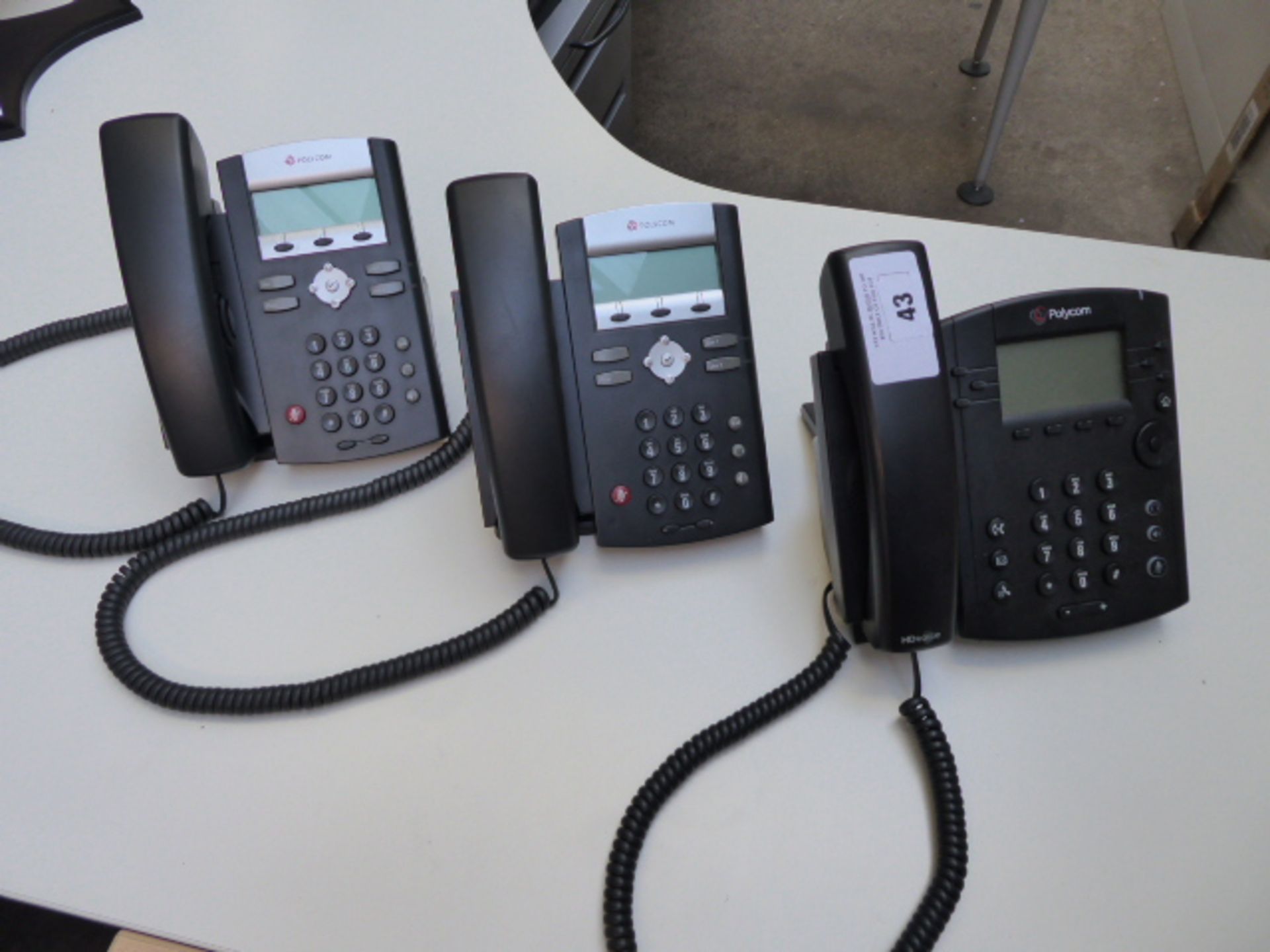 Three polycom telephone handsets