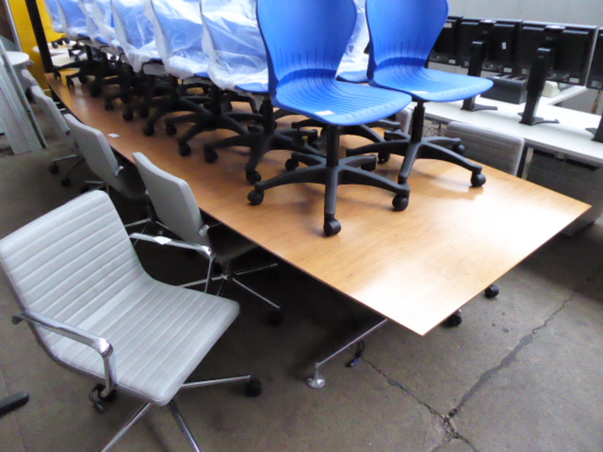 Large teak boardroom table in 3 sections on splayed chrome legs with padded feet, measuring 420cm