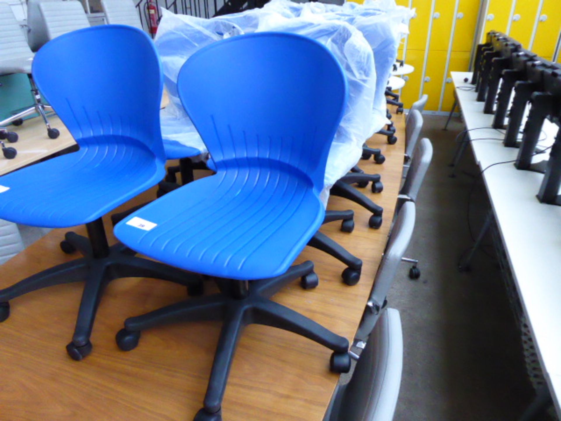 Ten blue plastic seated and black base swivel chairs