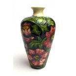 A modern Moorcroft vase of shouldered form decorated with stylised flowers on a dark blue ground, h.