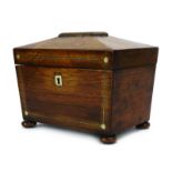 A Regency rosewood tea caddy of sarcophagus form with mother-of-pearl inlay and bun feet, w. 21.