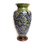 A Doulton Lambeth stoneware vase of baluster form relief decorated with stylised flowerheads and
