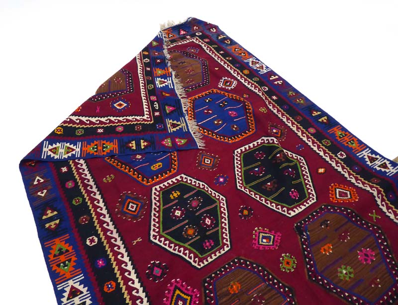 A hand woven Kelim carpet decorated with hexagonal motifs in various shades on a claret ground, - Image 3 of 3